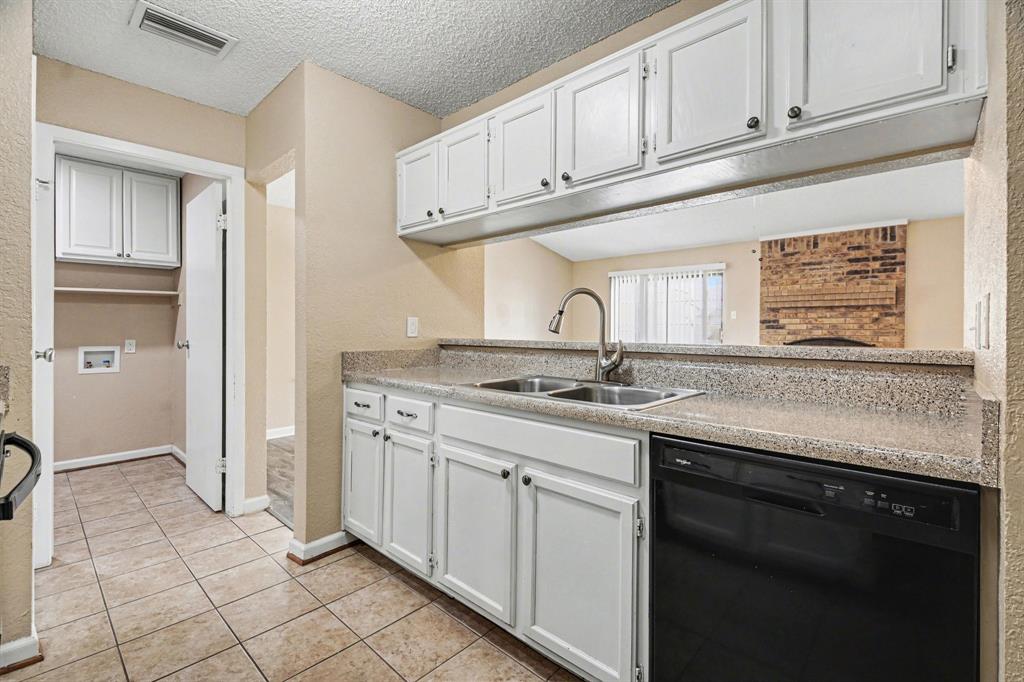1024 South Riverside Drive Grapevine, TX 76051 - Photo 10 of 21 a kitchen with stainless steel appliances granite countertop a sink stove and cabinets