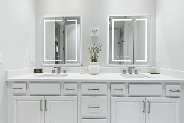 a white toilet sitting next to a white shower