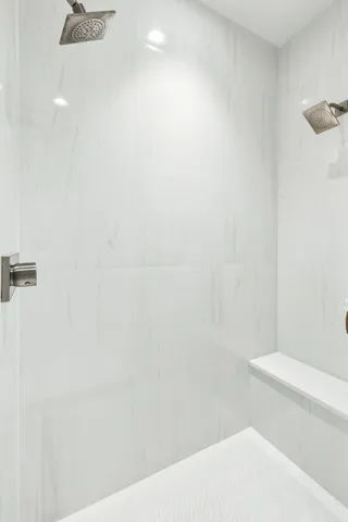 a bedroom with a large bed and a flat screen tv