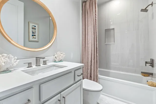 a living room with furniture and a book shelf