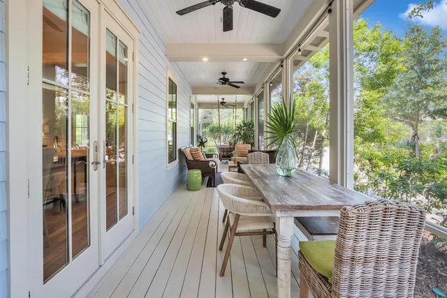 a outdoor dining space with furniture and wooden floor