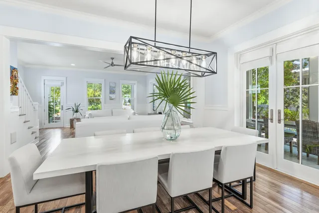 a dining room with furniture a chandelier and wooden floor