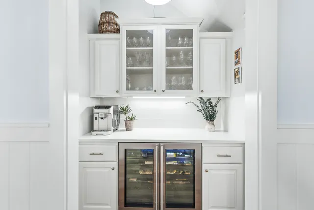 a kitchen with stainless steel appliances a table chairs and a refrigerator