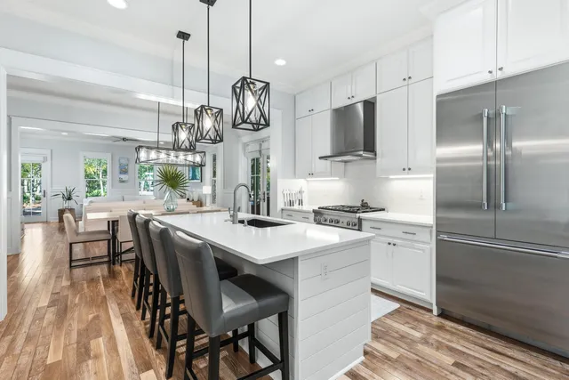 a kitchen with stainless steel appliances granite countertop a sink and a refrigerator
