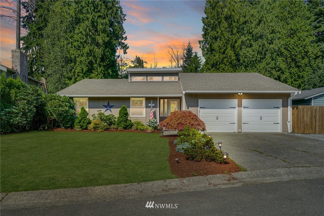 1912 169th Place Southeast Bothell, WA 98012 - Photo 2 of 40 a front view of a house with a yard and trees