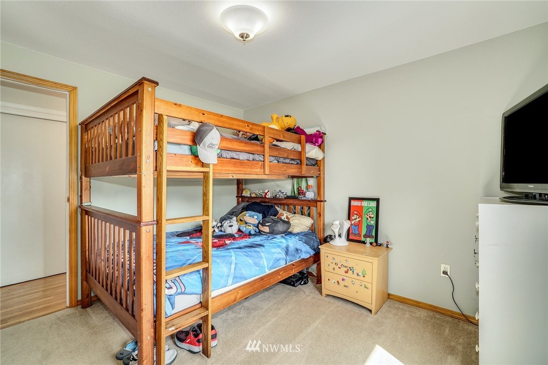 1912 169th Place Southeast Bothell, WA 98012 - Photo 17 of 40 a bed room with furniture and a flat screen tv