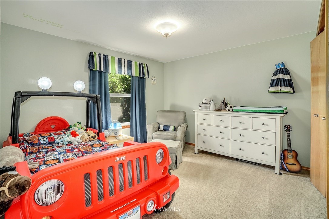 1912 169th Place Southeast Bothell, WA 98012 - Photo 18 of 40 a bedroom with a bed and a dresser in it