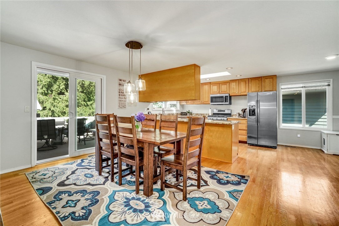 1912 169th Place Southeast Bothell, WA 98012 - Photo 8 of 40 a view of a dining room with furniture window and wooden floor