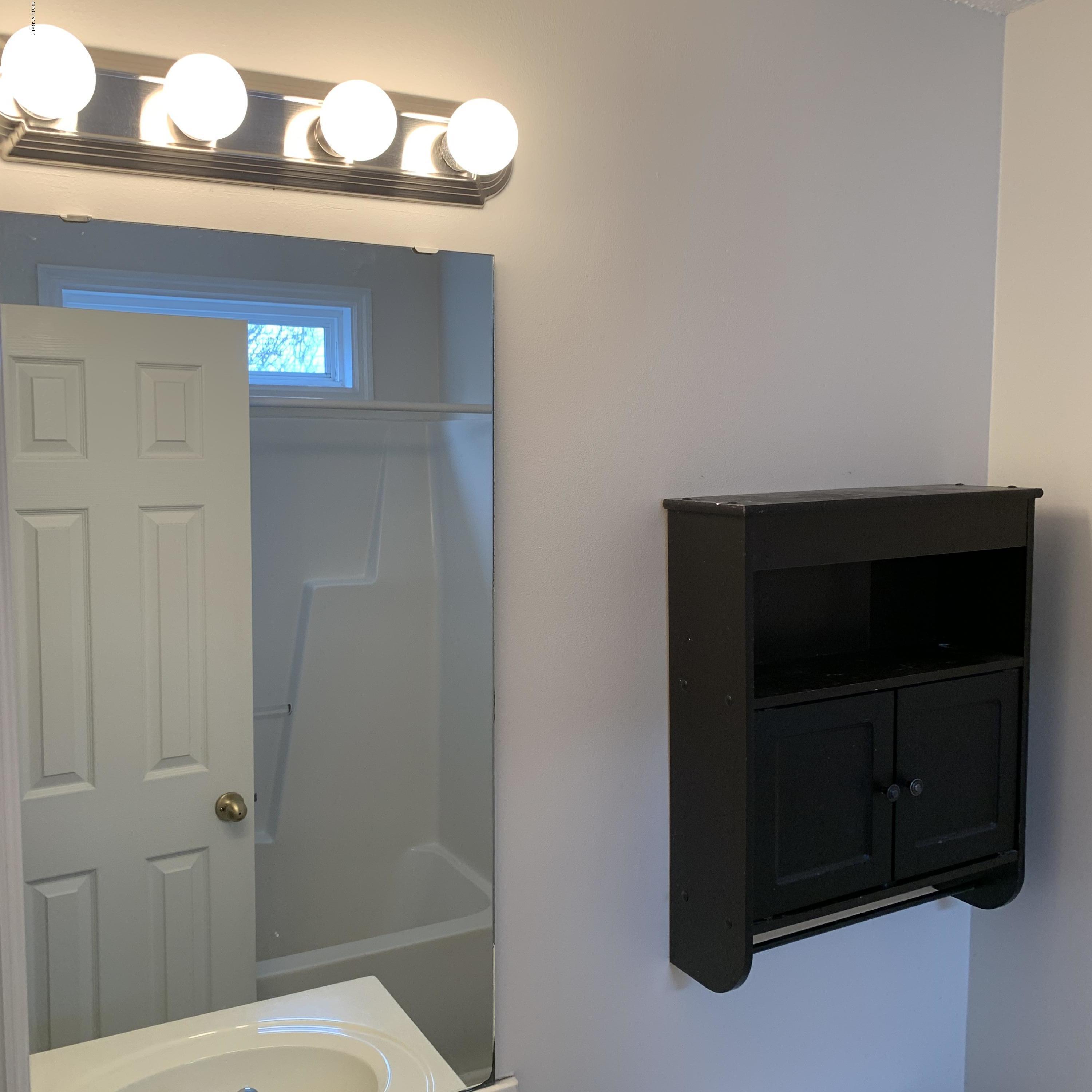 4910 Bridger Road, Unit #14 Shallotte, NC 28470 - Photo 22 of 37 Upstairs first Full Bathroom off Rear Bedroom with Transom Window