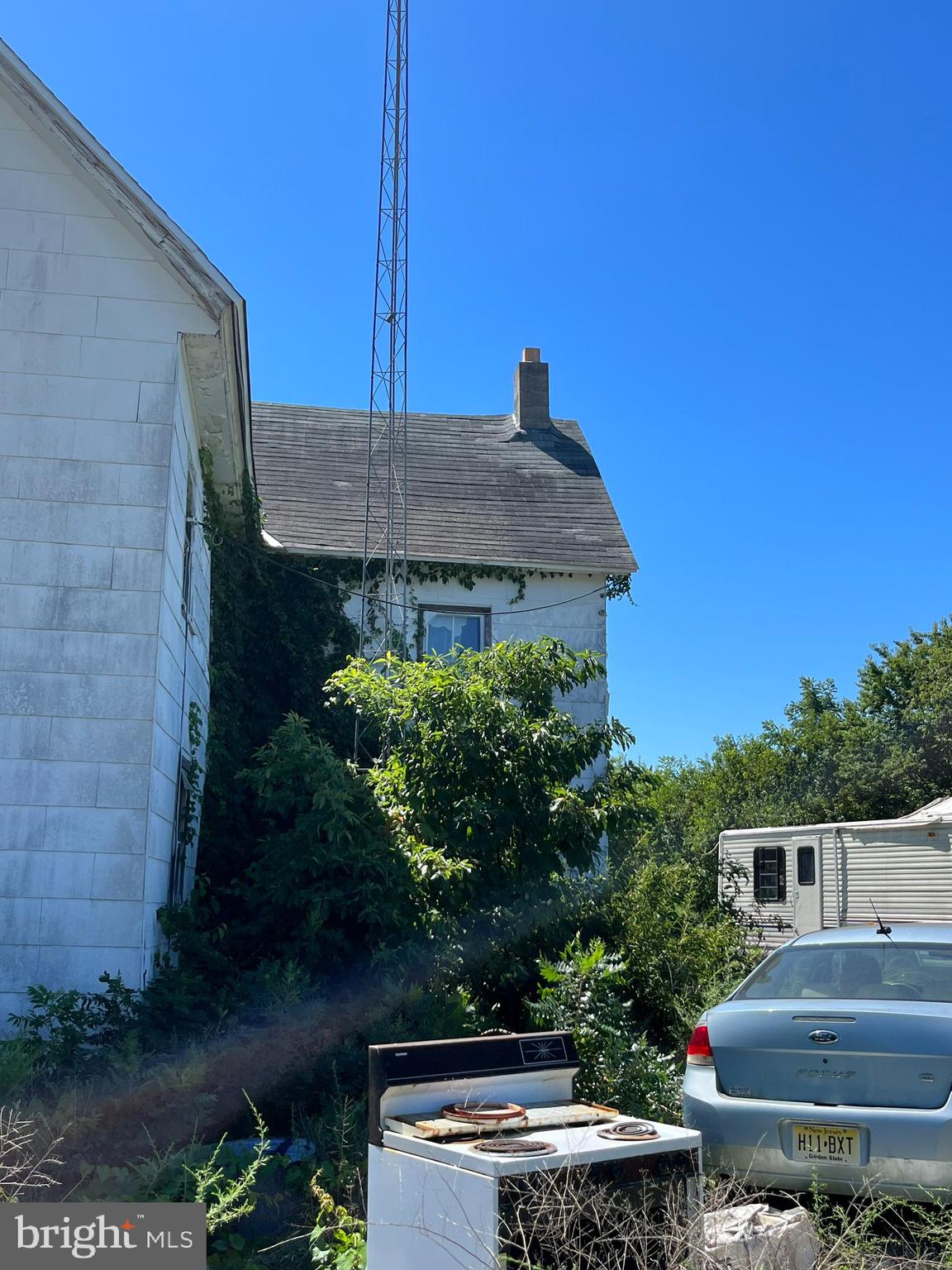484 Gum Tree Corner Road Bridgeton, NJ 08302 - Photo 9 of 29 a backyard of a house with plants and outdoor seating