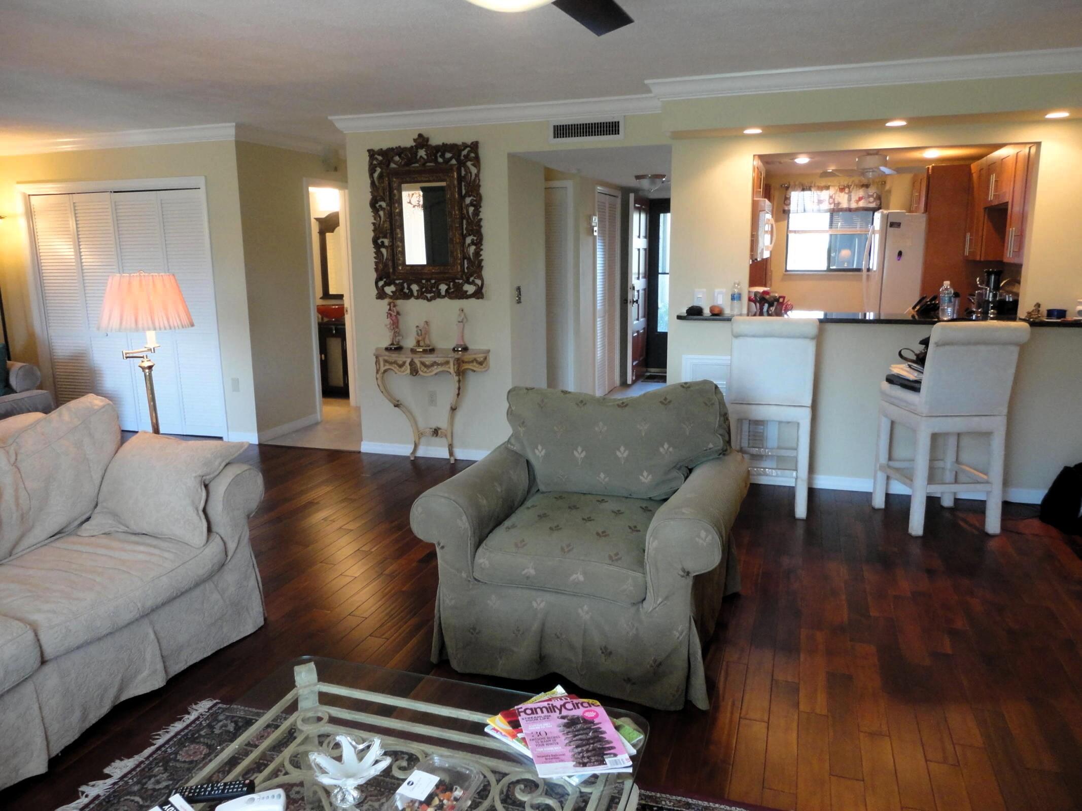 5433 Southeast Miles Grant Road, Unit 104 Stuart, FL 34997 - Photo 3 of 16 Living room and kitchen