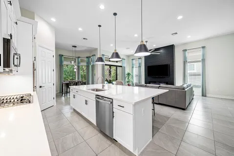 a kitchen with stainless steel appliances granite countertop a sink and a stove