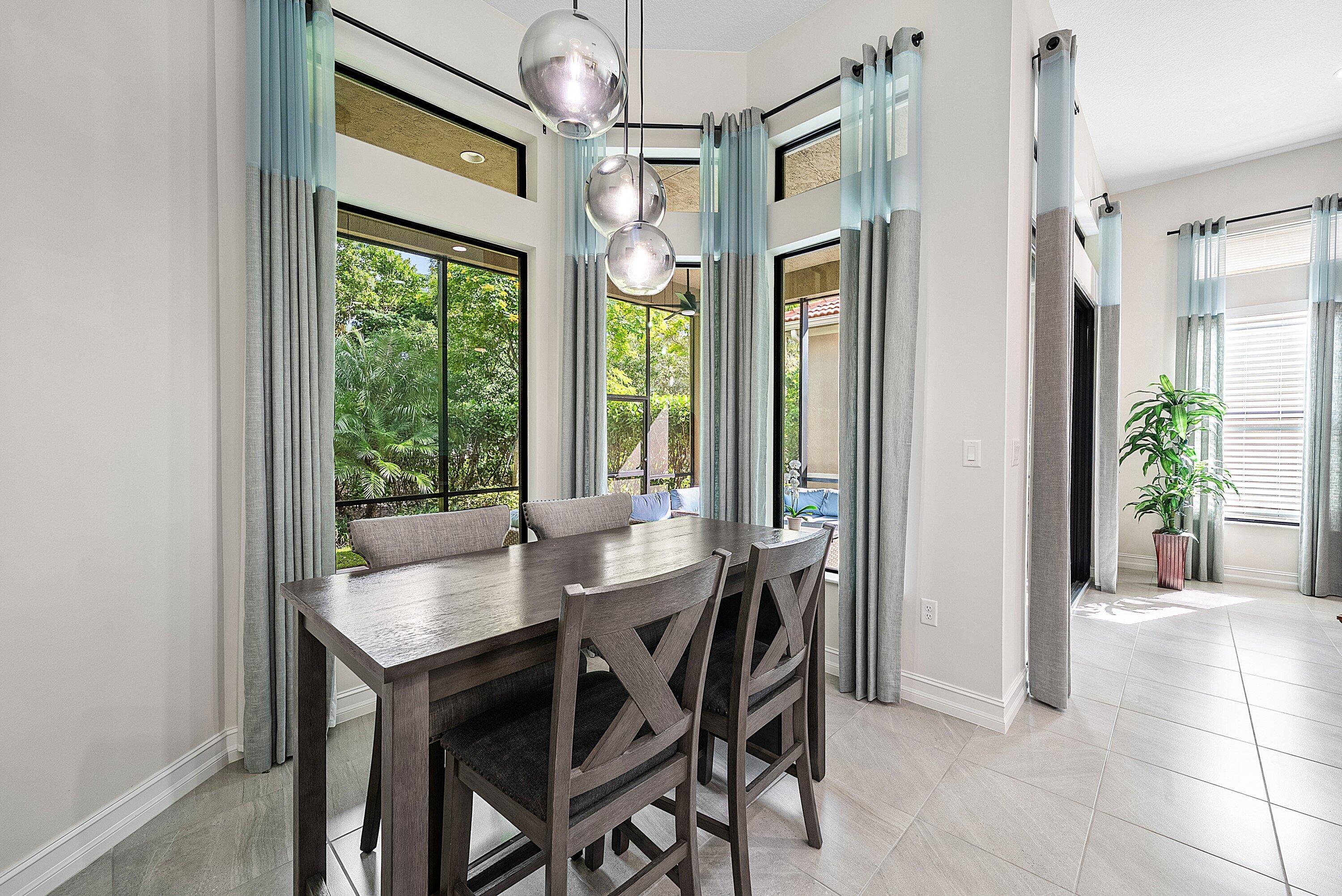 9076 Leon Circle Parkland, FL 33076 - Photo 16 of 42 a view of a dining room with furniture and a window