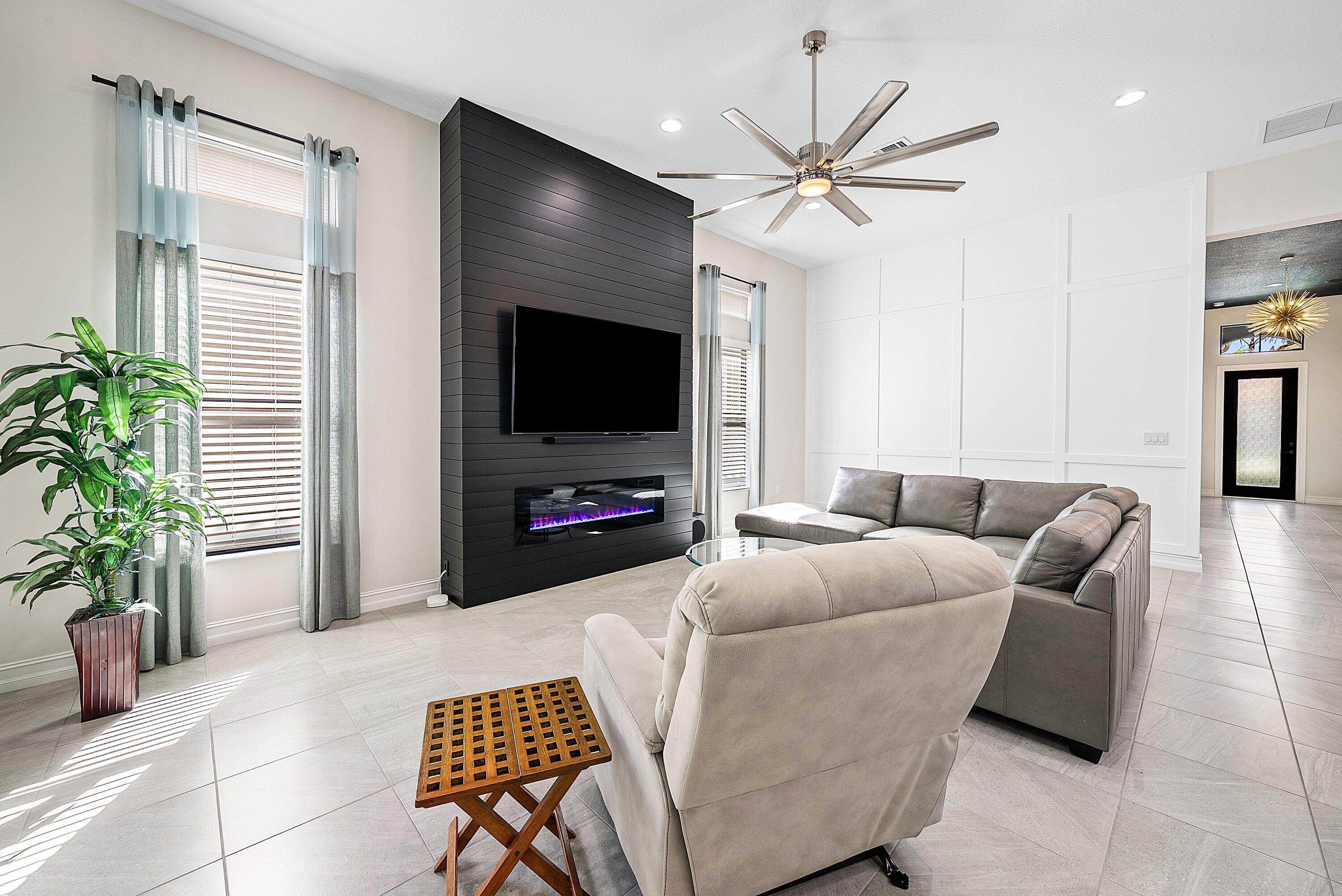 9076 Leon Circle Parkland, FL 33076 - Photo 18 of 42 a living room with furniture and a flat screen tv