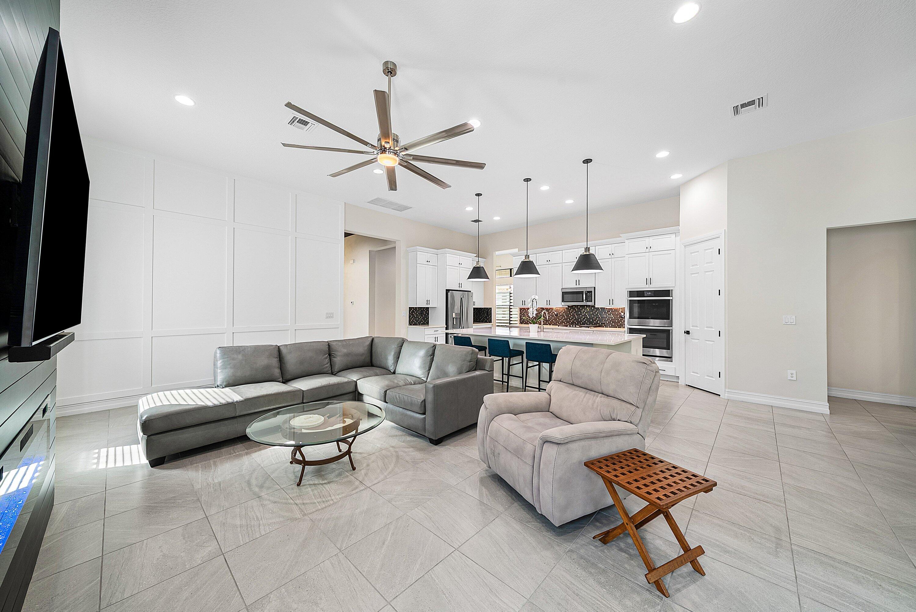 9076 Leon Circle Parkland, FL 33076 - Photo 21 of 42 a living room with furniture and a flat screen tv