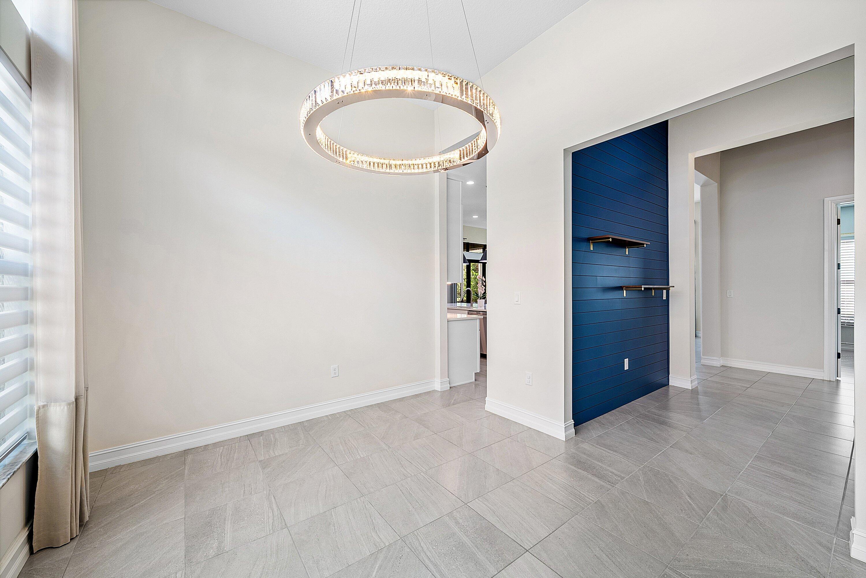 9076 Leon Circle Parkland, FL 33076 - Photo 22 of 42 an empty room with a fireplace and wooden floor