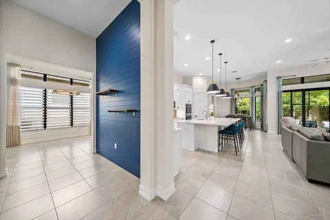 a spacious bedroom with a bed and a chandelier