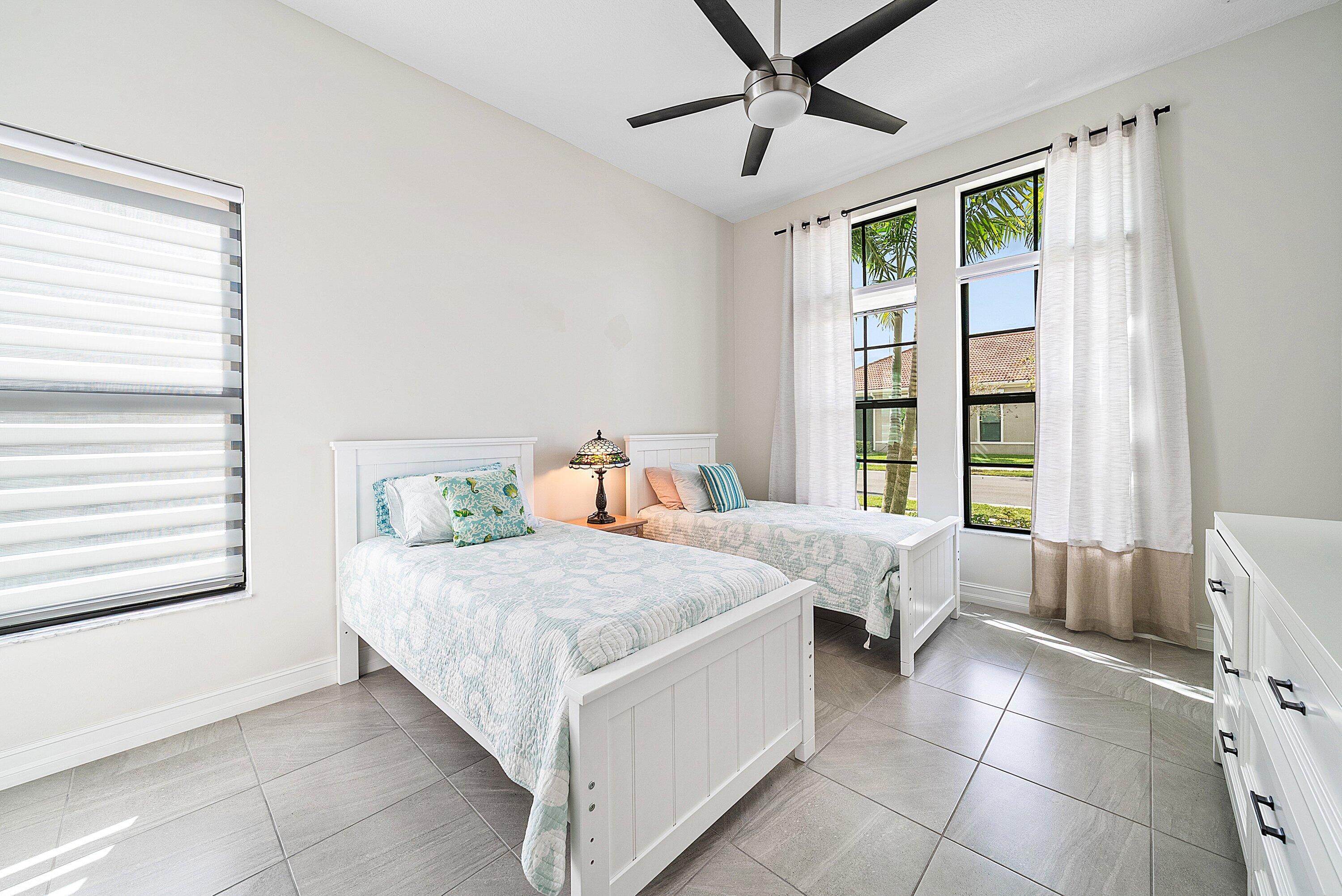 9076 Leon Circle Parkland, FL 33076 - Photo 29 of 42 a bedroom with a bed and a window
