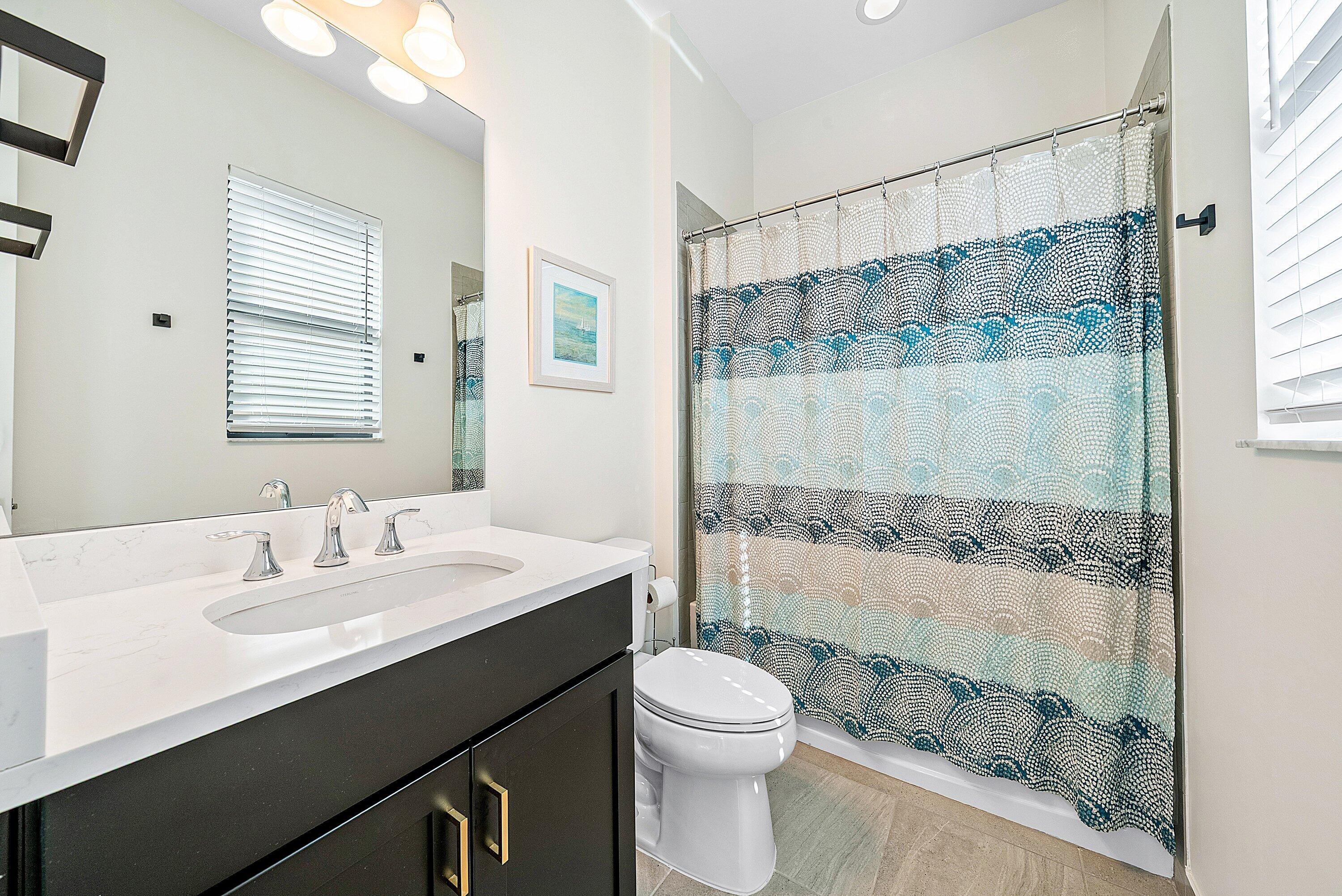 9076 Leon Circle Parkland, FL 33076 - Photo 30 of 42 a bathroom with a sink a toilet and shower