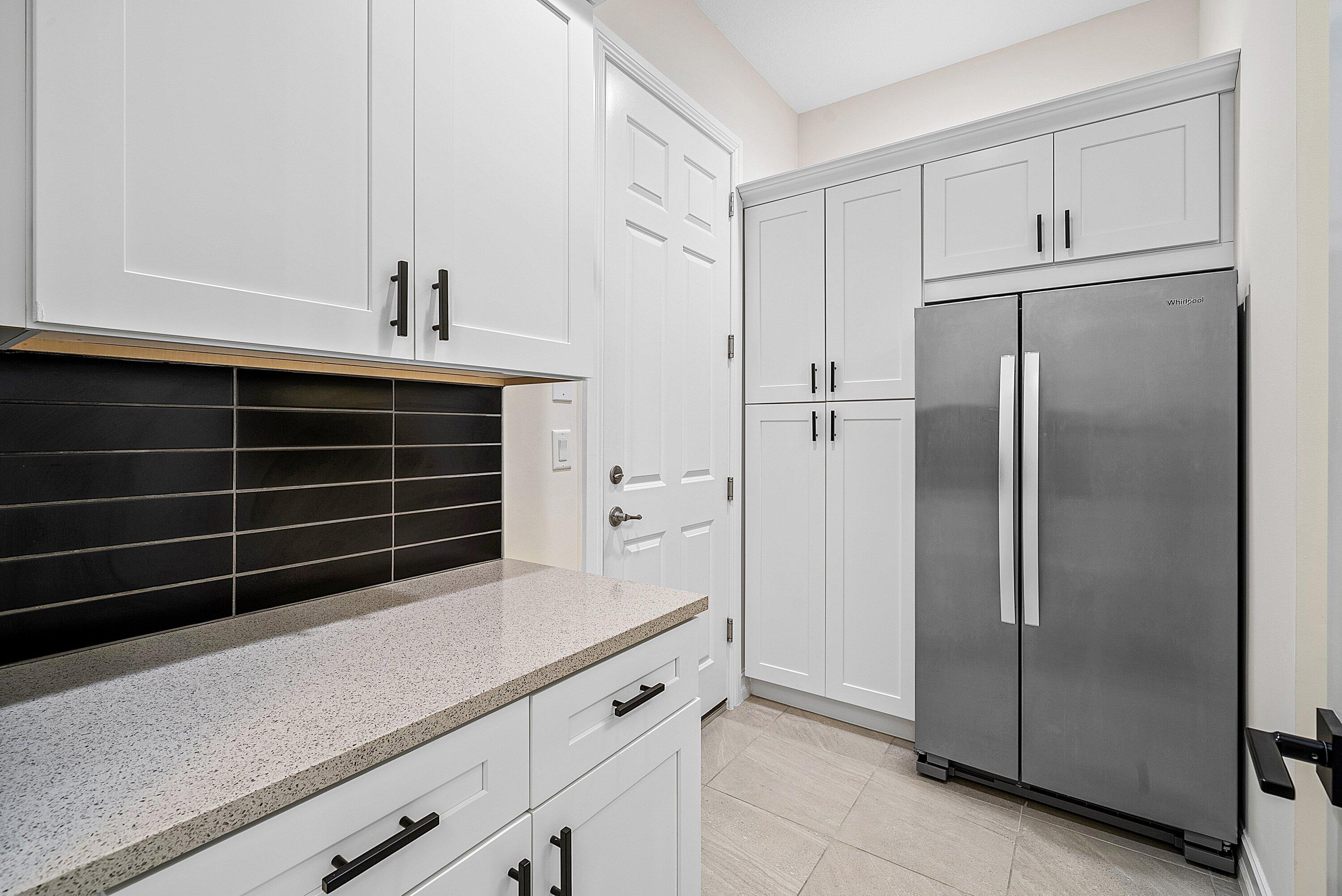 9076 Leon Circle Parkland, FL 33076 - Photo 33 of 42 a kitchen with appliances cabinets and a counter top space