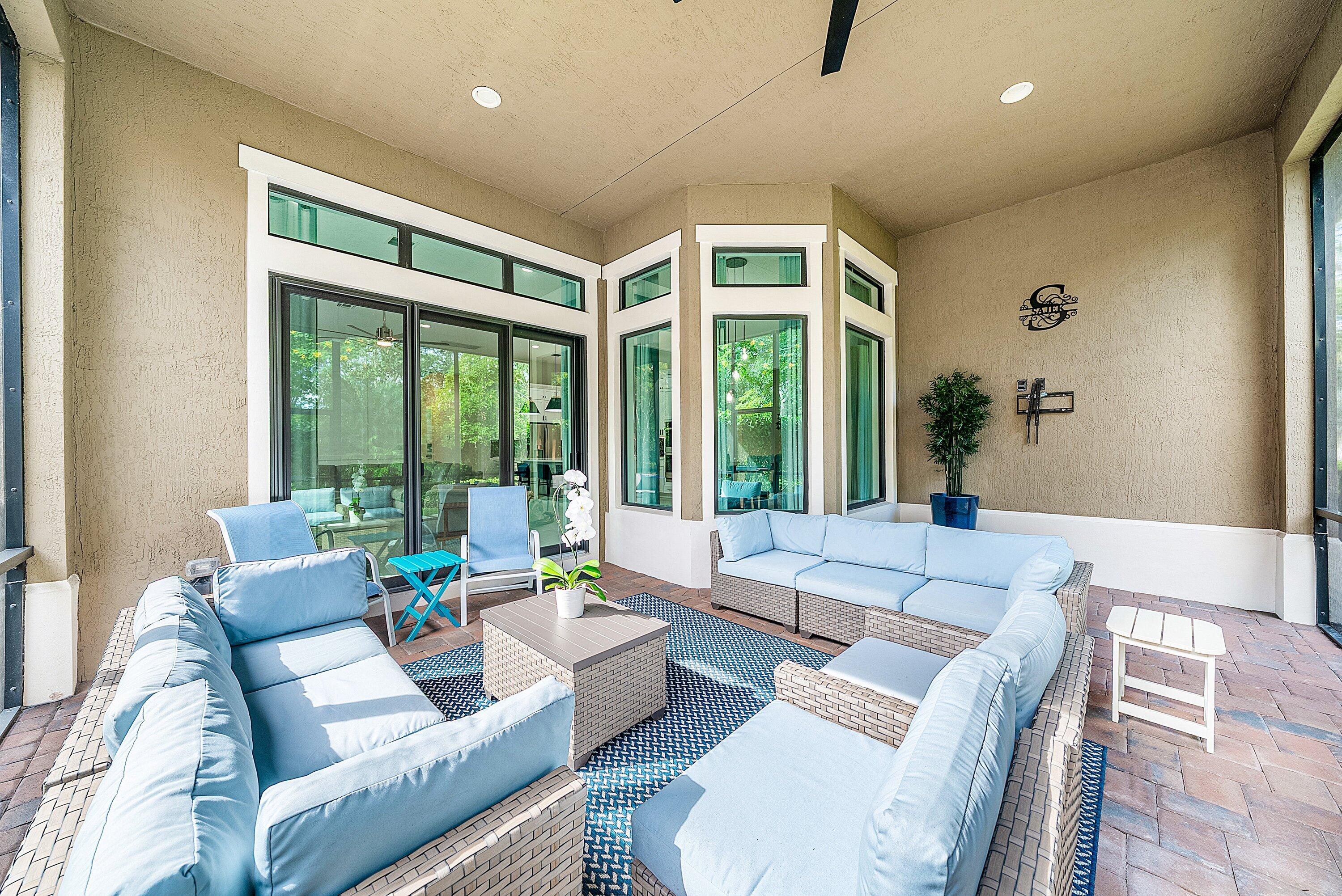 9076 Leon Circle Parkland, FL 33076 - Photo 37 of 42 a living room with furniture and large windows