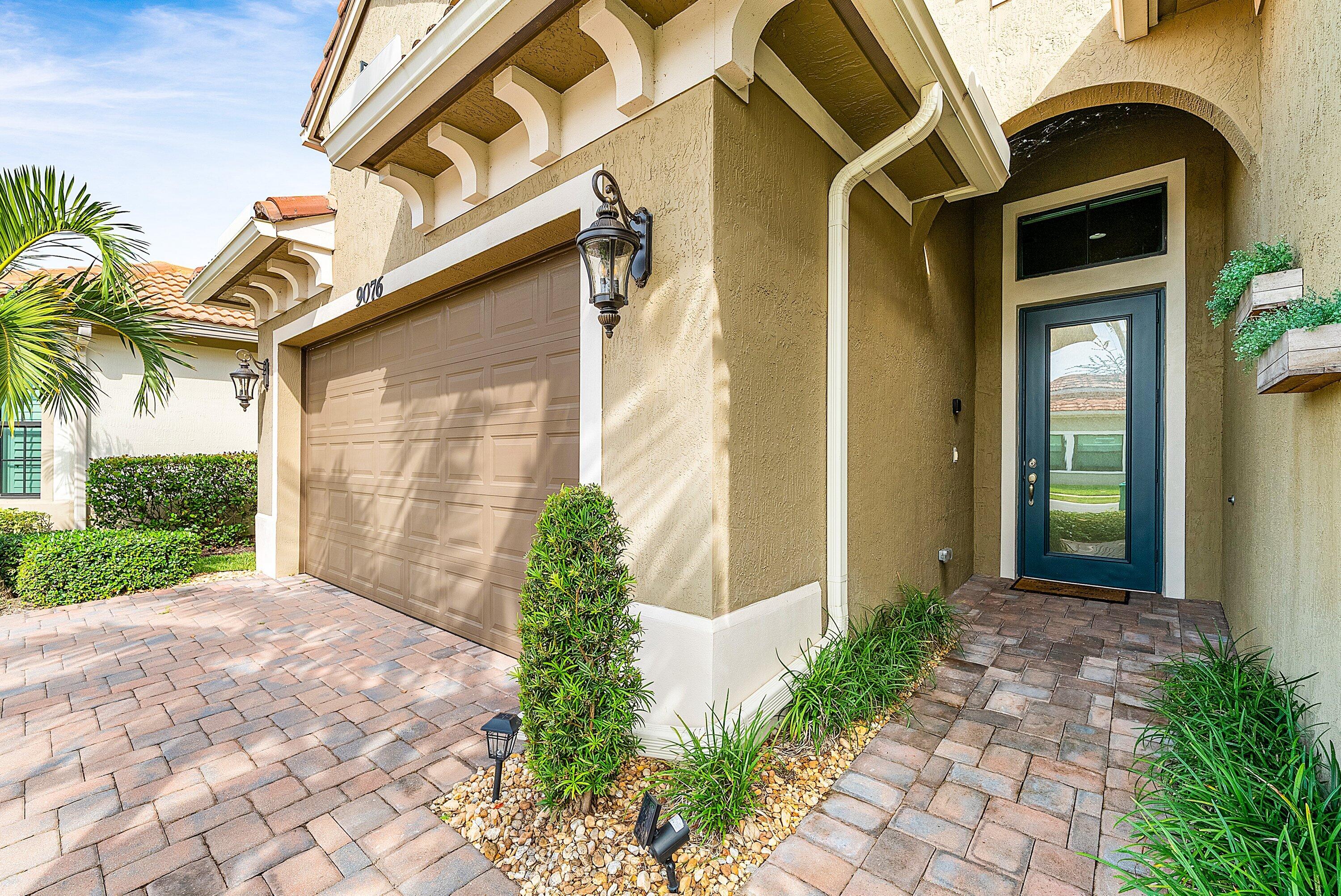 9076 Leon Circle Parkland, FL 33076 - Photo 5 of 42 a front view of a house with garden
