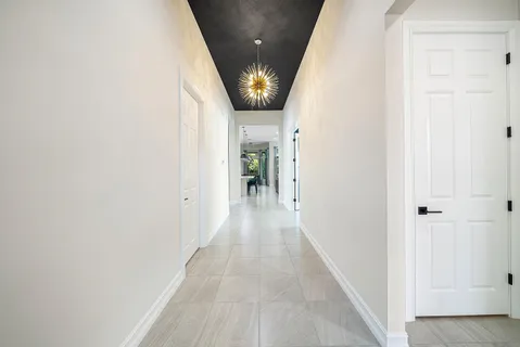 a view of a hallway with wooden floor and entryway