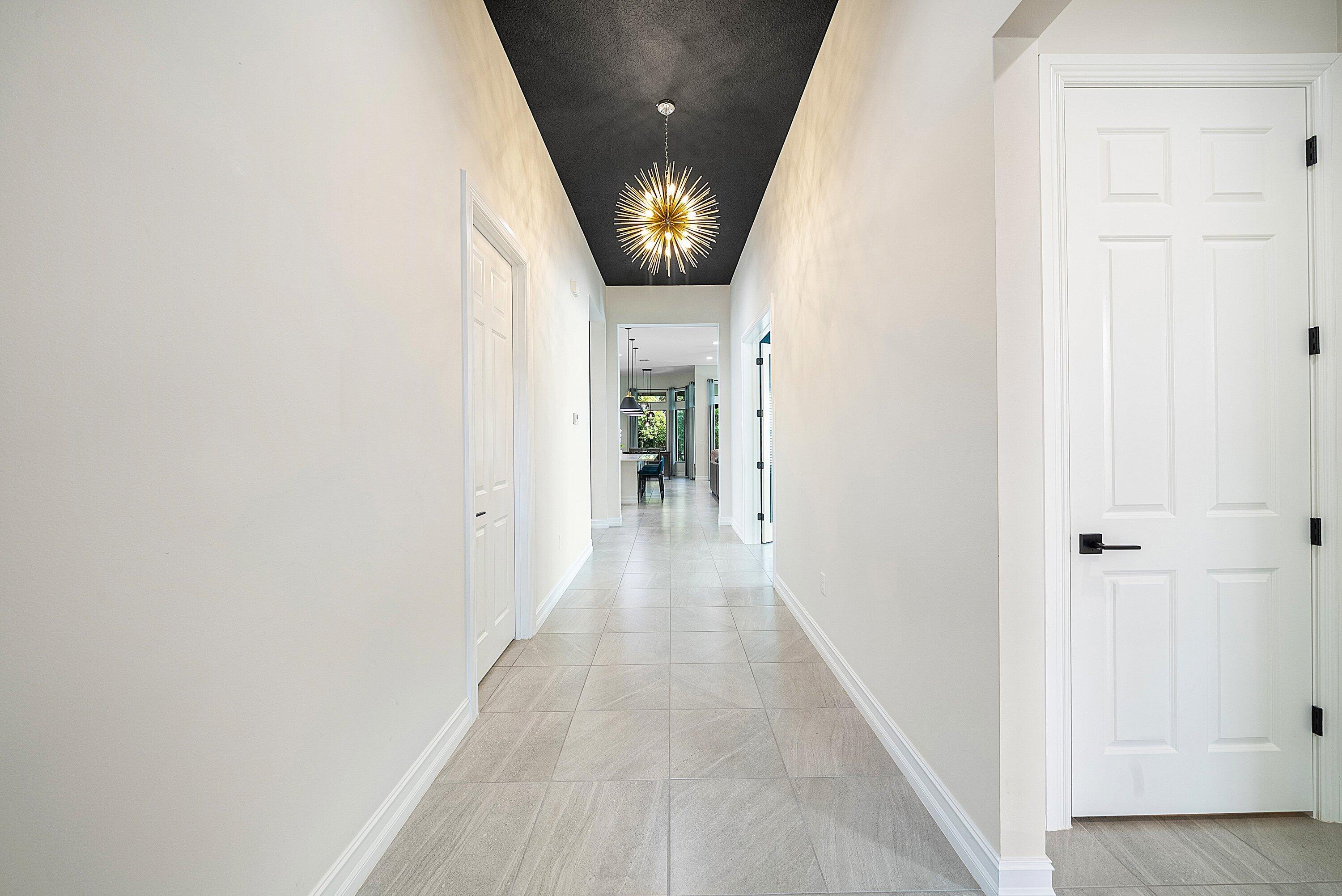 9076 Leon Circle Parkland, FL 33076 - Photo 6 of 42 a view of a hallway with wooden floor and entryway