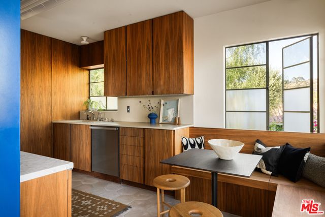 a kitchen with a sink and wooden cabinets