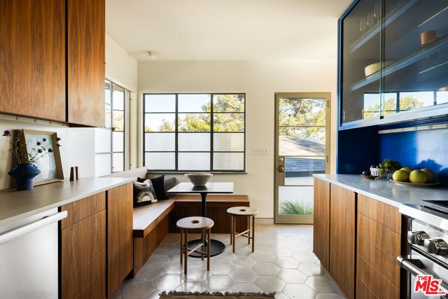 a living room with furniture and large windows