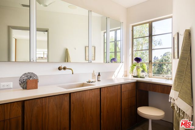 a bathroom with a sink and a large mirror