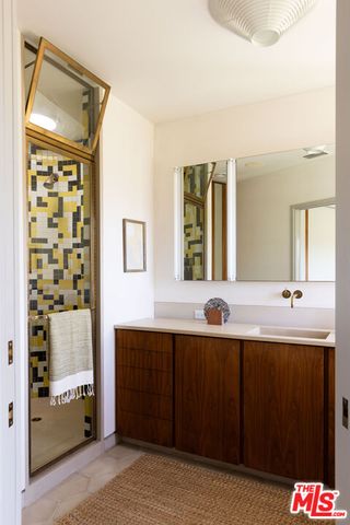 a bathroom with a black and white checkered floor