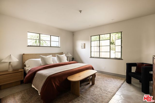 a bedroom with a bed and window
