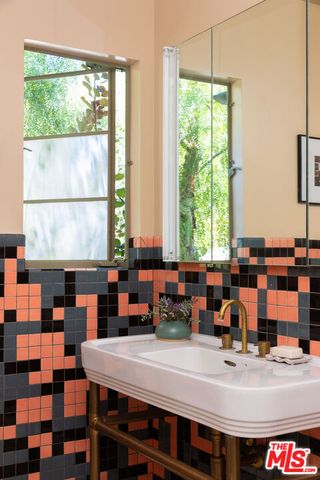 a bathroom with a sink double vanity and tub