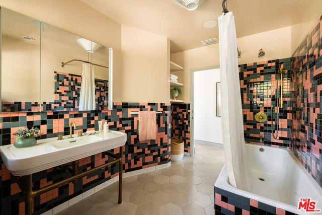 a picture of a bathroom with a shower and a sink