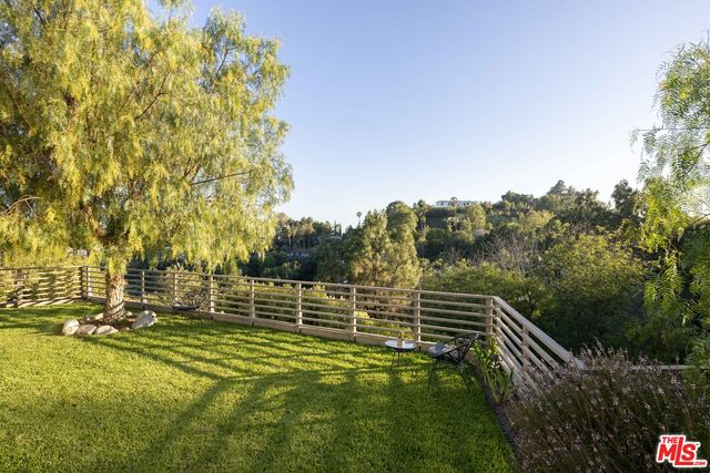 a view of a swimming pool with a table and a chair