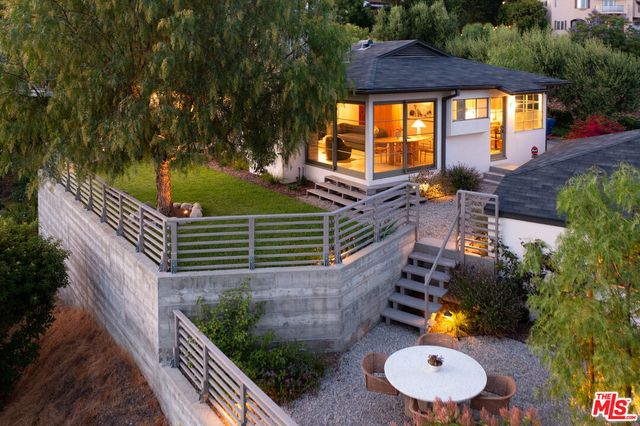 an aerial view of residential house with outdoor space and trees