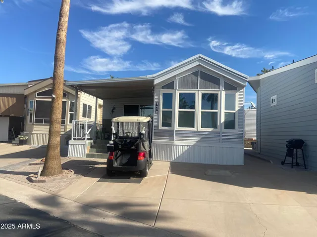 a front view of a house with outdoor seating