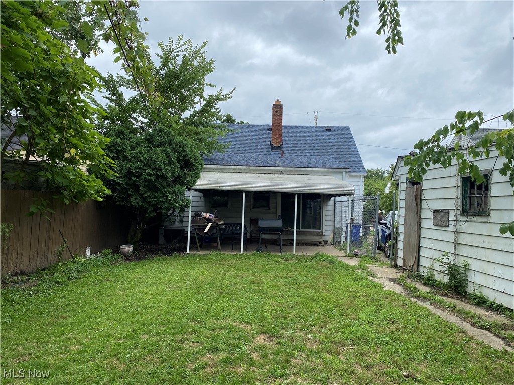 17011 Ridgeton Drive Cleveland, OH 44128 - Photo 34 of 35 Rear view of house with a yard