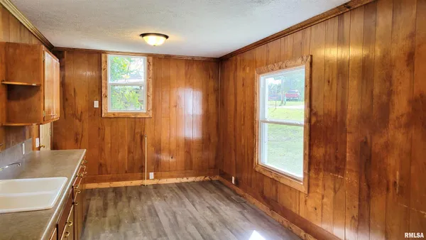 a view of a room with wooden floor and a window