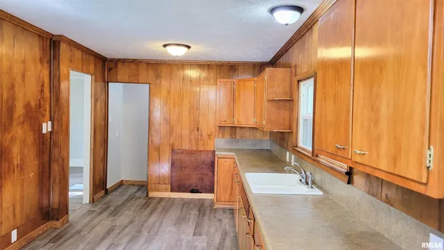 a view of a room with wooden floor and door