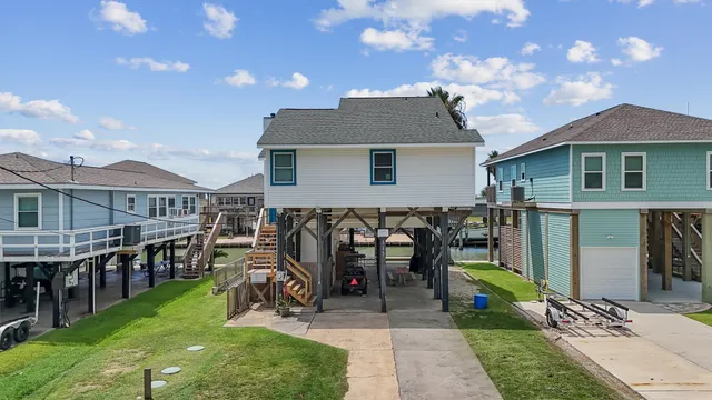 a view of a house with a yard and sitting area
