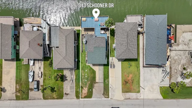 an aerial view of residential houses with outdoor space and street view