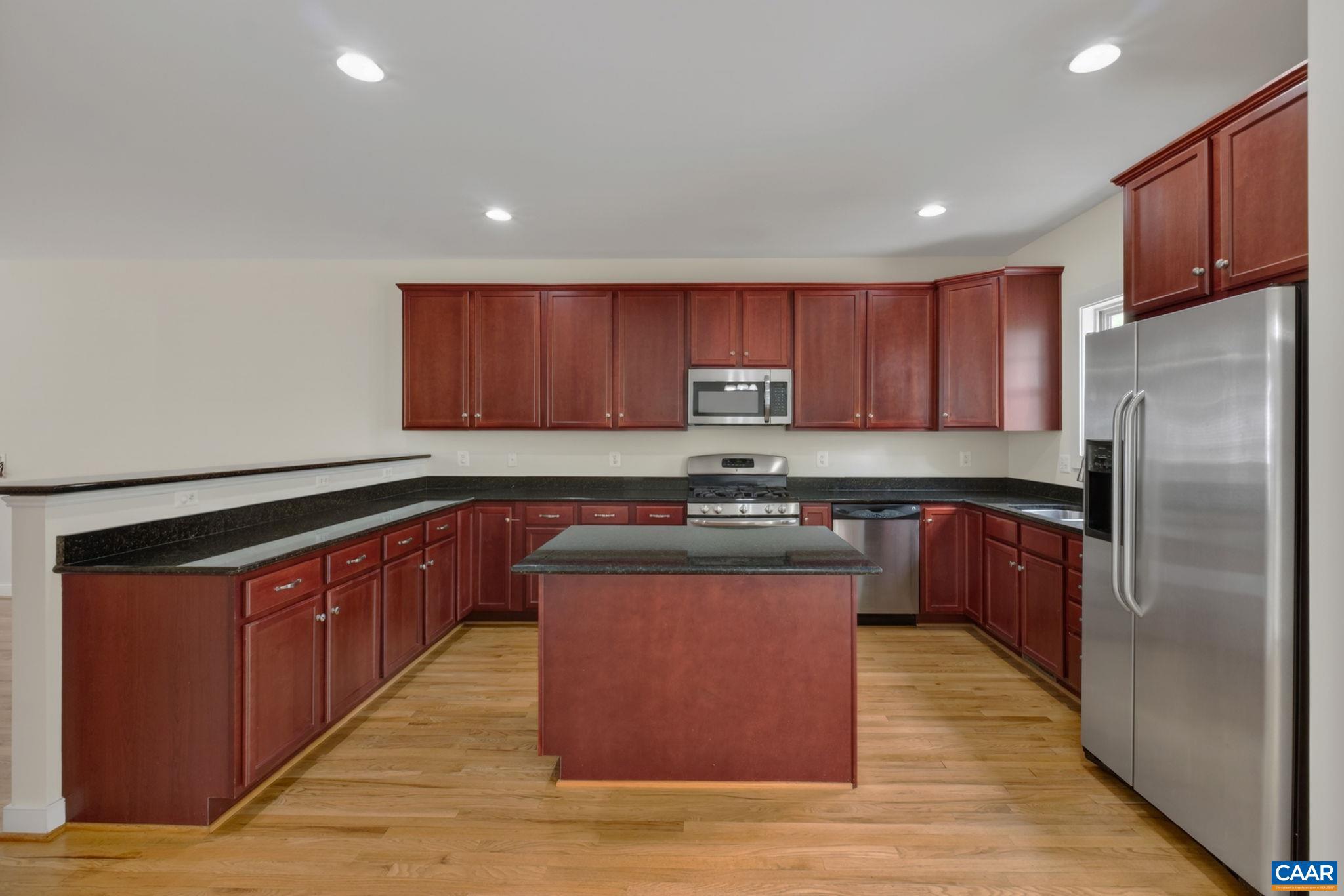 2138 Sundown Place Charlottesville, VA 22911 - Photo 14 of 38 a kitchen with stainless steel appliances granite countertop a stove a refrigerator and a sink