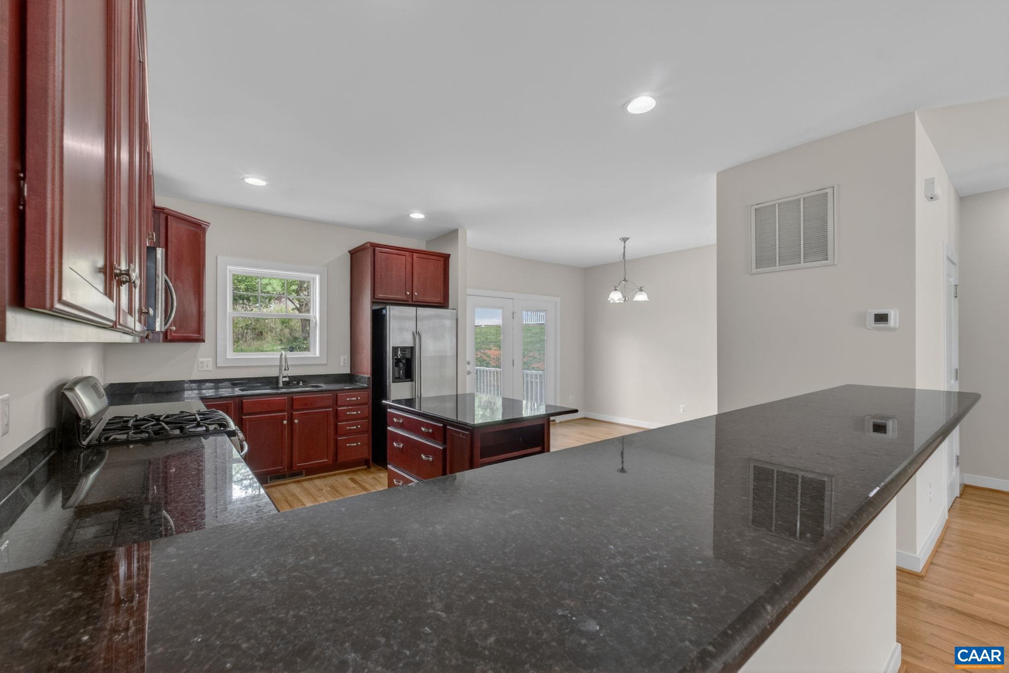 2138 Sundown Place Charlottesville, VA 22911 - Photo 18 of 38 a kitchen with stainless steel appliances granite countertop a sink stove and cabinets