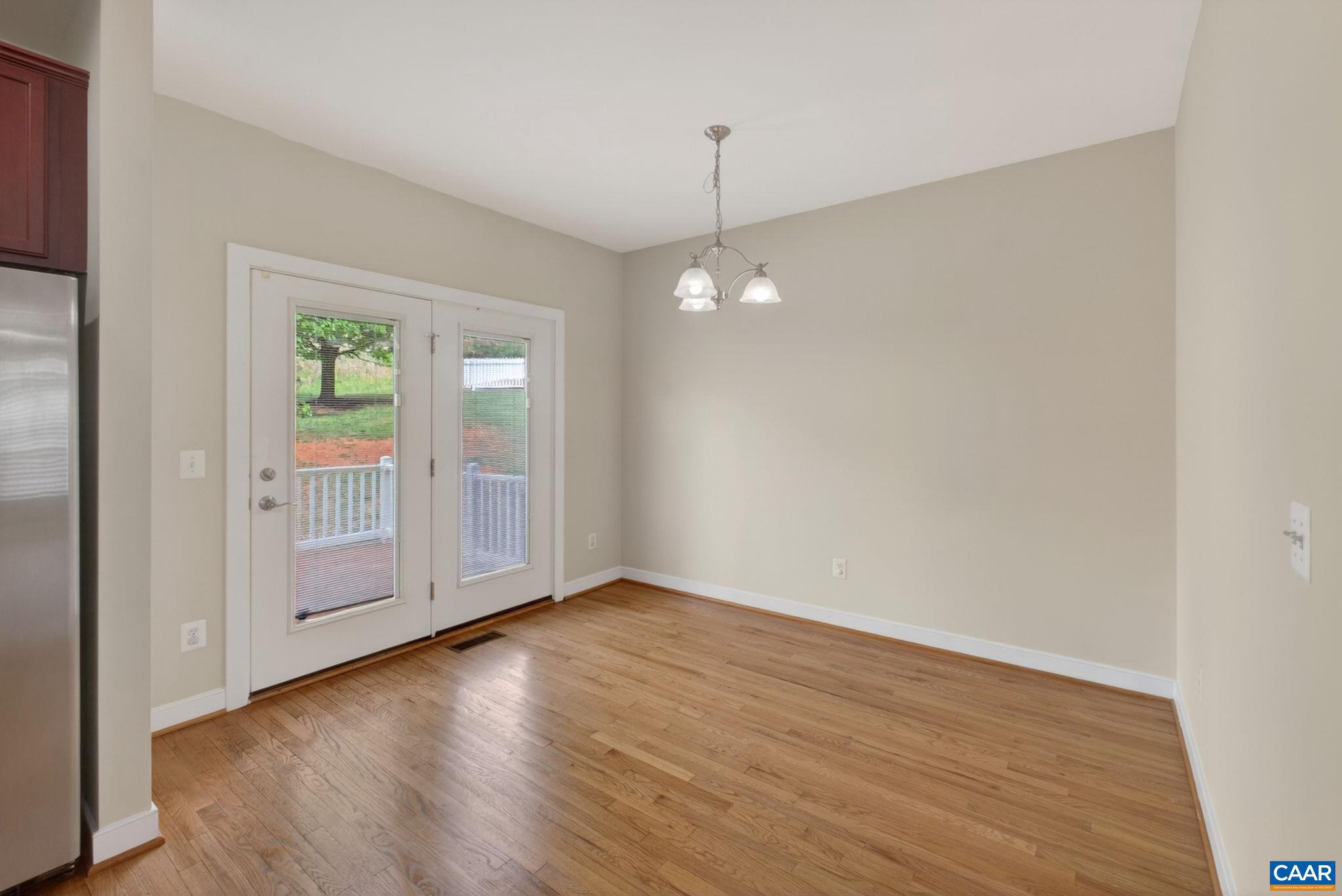 2138 Sundown Place Charlottesville, VA 22911 - Photo 20 of 38 a view of an empty room with wooden floor and a window