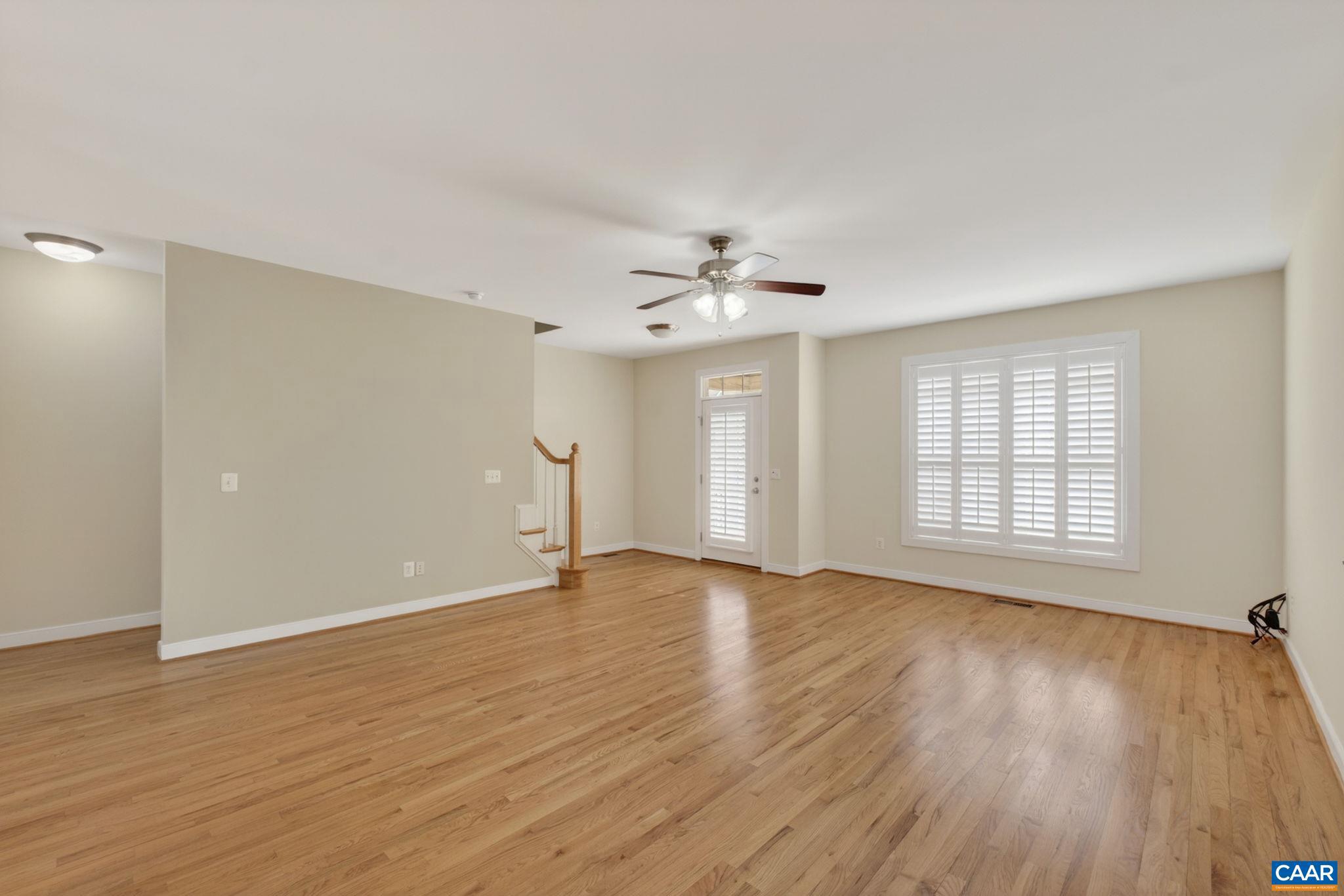 2138 Sundown Place Charlottesville, VA 22911 - Photo 8 of 38 a view of an empty room with wooden floor and a window