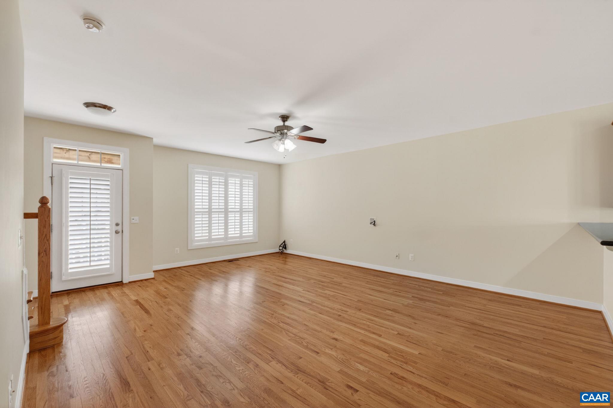 2138 Sundown Place Charlottesville, VA 22911 - Photo 9 of 38 a view of an empty room with wooden floor and a window