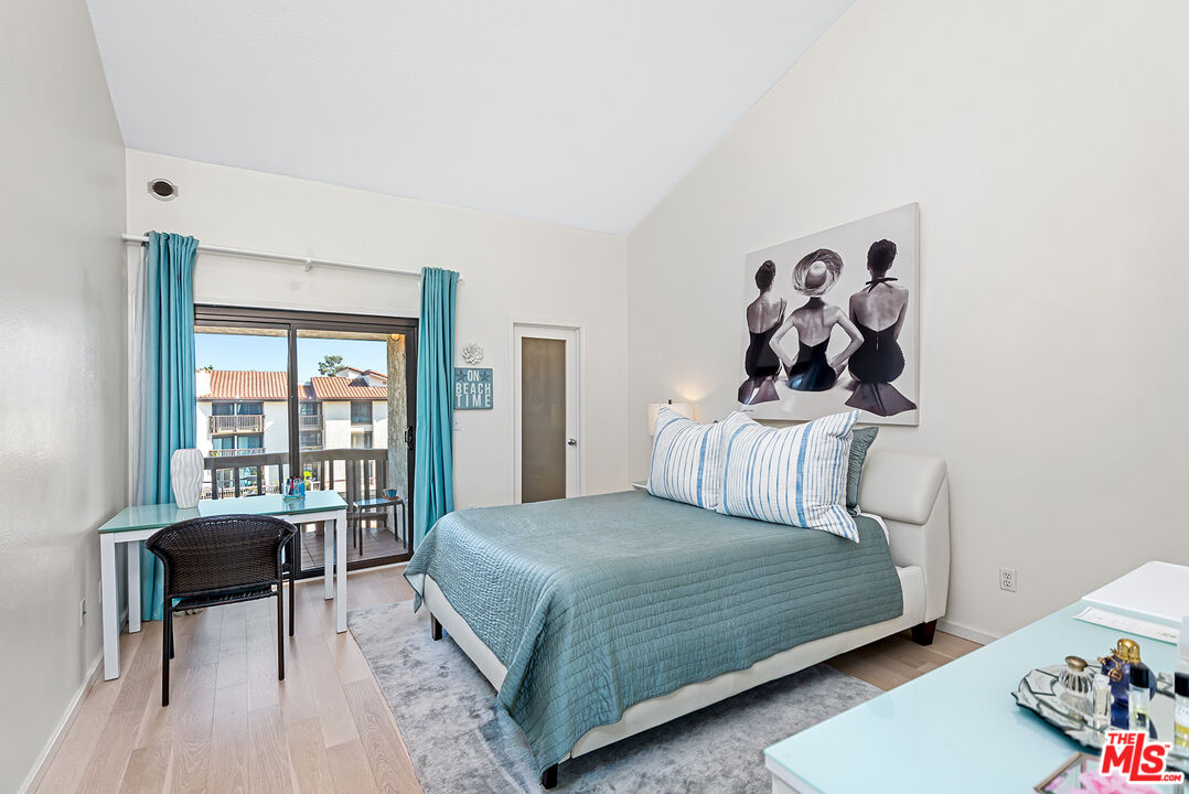 8600 Tuscany Avenue, Unit 419 Playa del Rey, CA 90293 - Photo 16 of 35 a bedroom with a bed and a table in it