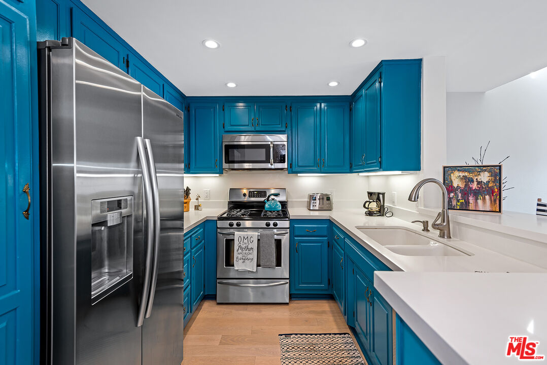 8600 Tuscany Avenue, Unit 419 Playa del Rey, CA 90293 - Photo 3 of 35 a kitchen with a sink a refrigerator and a sink
